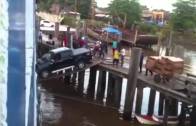 Car boarding ship over a wooden plank