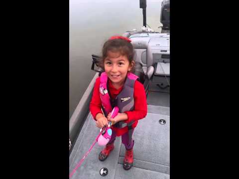 Little girl catches a huge sea bass
