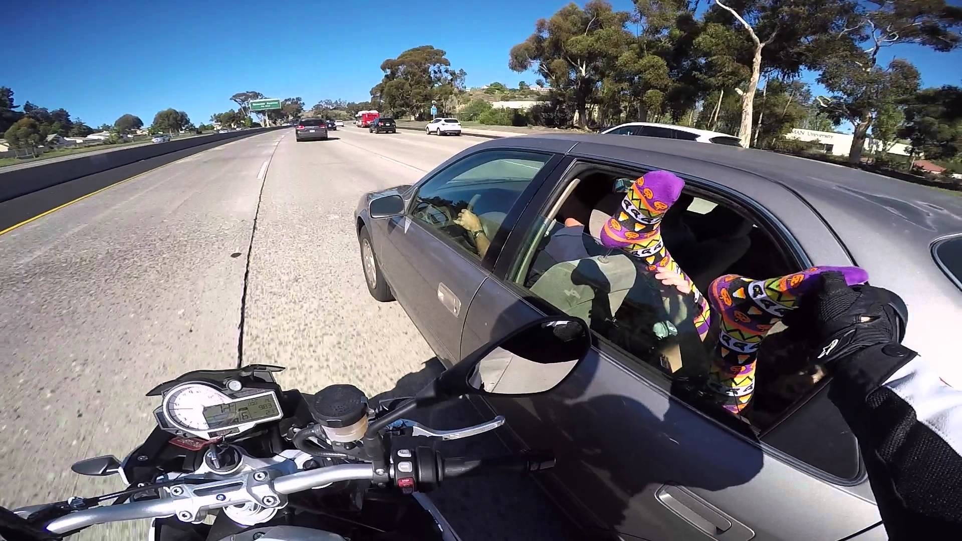 Motorcyclist touches feet on the freeway
